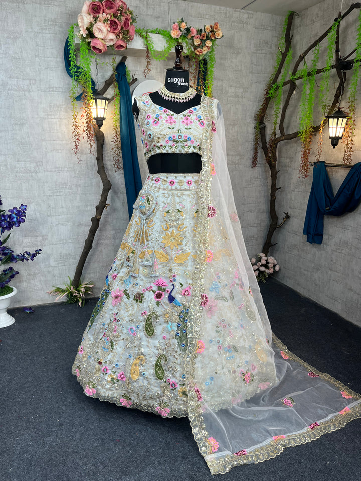 A displayed lehenga set with sequin embroidery and cut work on an organza silk fabric, including a Lehenga, a blouse piece, and a dupatta, with a mannequin showcasing the attire.