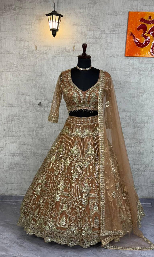 Gold embroidered traditional outfit on a mannequin against a textured wall.